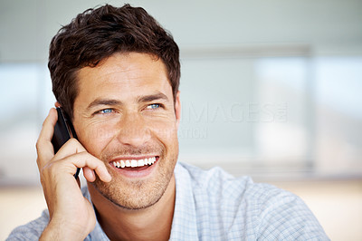 Smart young guy enjoying a conversation on cellphone