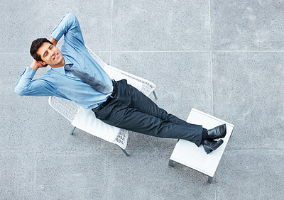 Businessman sitting down and relaxing outside