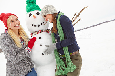 They\'re very proud of the snowman they made