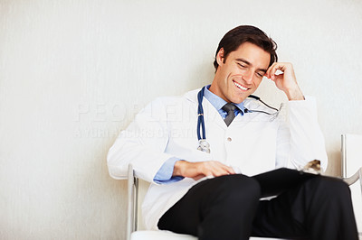 Young doctor looking at medical reports at hospital