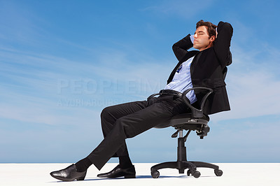 Relaxed business man sitting on an office chair