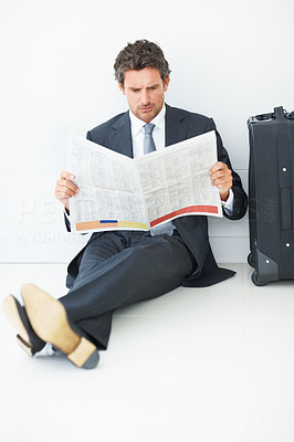 Middle aged business man reading newspaper