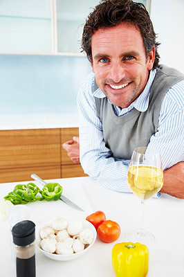 Happy mature man smiling in the kitchen