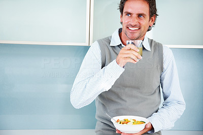 Smiling mature man with appetizer and fruit salad