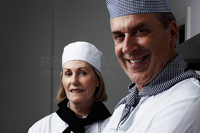 Closeup of a happy male and female chefs smiling