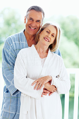 Loving mature man embracing woman from back