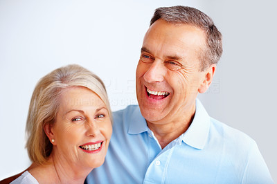 Cheerful senior man and woman having a good time against white