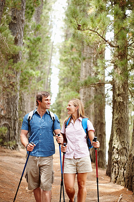 Hiking couple smiling and looking at each other