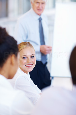 Pretty business woman with team in meeting