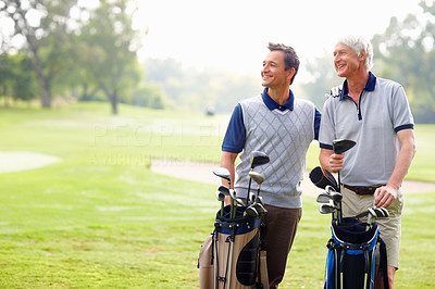Happy father and son on a golf course