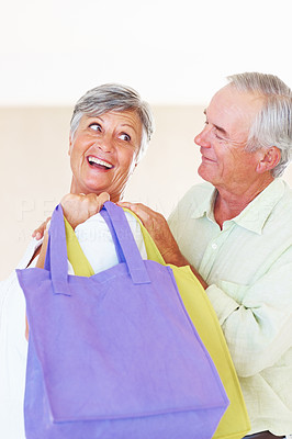 Mature couple with shopping bags