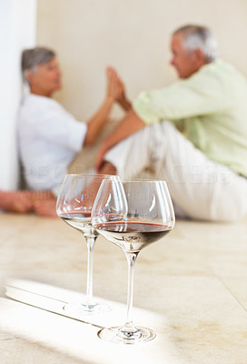Couple enjoying at home with wine glasses
