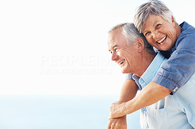 Happy woman enjoying piggyback ride with mature man
