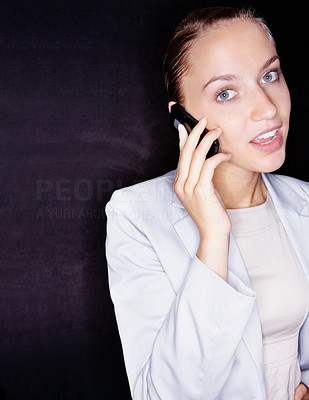 Confused business woman speaking over cellphone