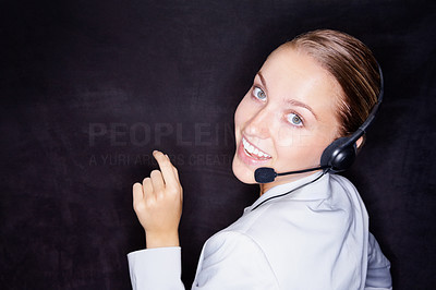 Pretty business woman with a headset on black , copyspace