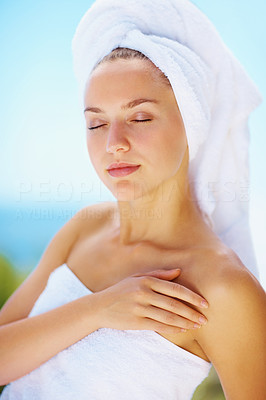 Fresh female with eyes closed wrapped in a towel