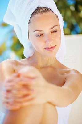 Cute thoughtful woman in a towel before a spa treatment