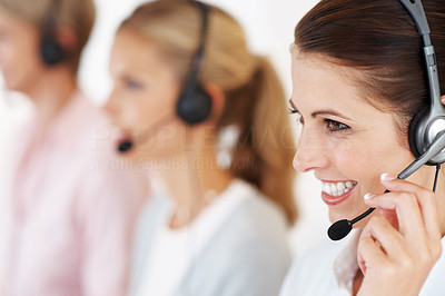 Call center employee with colleagues in background