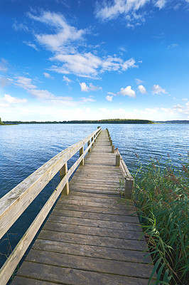 A photo of a wooden jetty and lake
