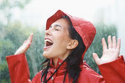 Joyful woman playing in rain
