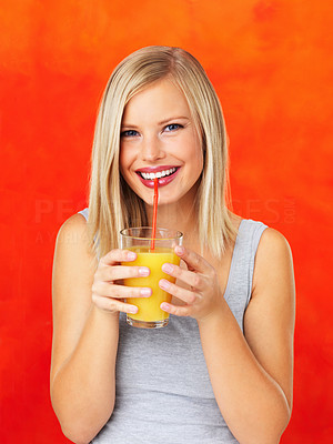 Happy woman sipping orange juice
