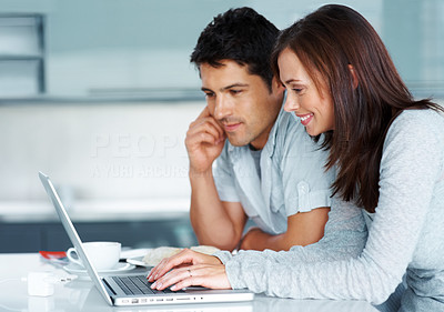 Young couple working together on laptop