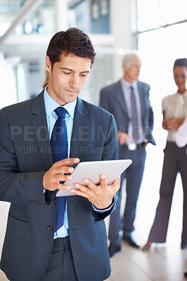 Handsome business man using electronic tablet