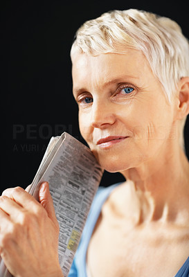 Closeup of a aged lady holding newspaper