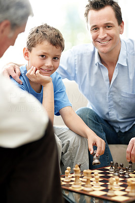 Portrait of a father ansd son playing chess