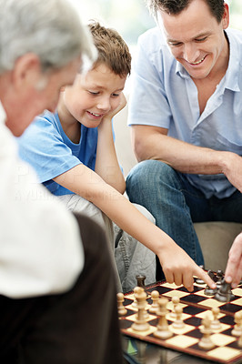 Happy family having a game of chess