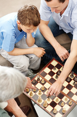 Top view of family playing a game of chess