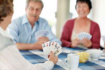 Enjoying retirement - Senior people playing cardgame