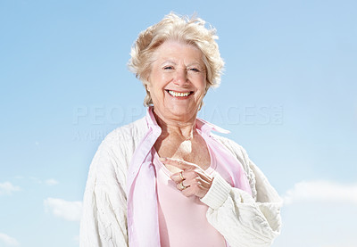 Happy senior female pointing at copyspace