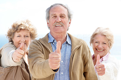 Group of happy old friends showing thumbs up sign