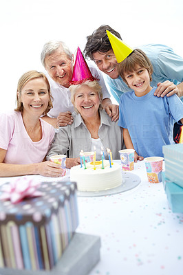 Happy old woman celebrating her birthday with her family