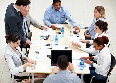 Business meeting - Executives gathered together aroung a table
