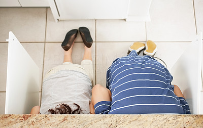 Top view of a couple searching something in kitchen counter
