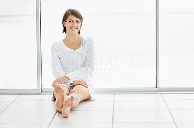 Happy woman sitting on the floor , copyspace to paste your text