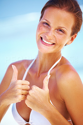 Smiling woman giving thumbs up