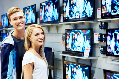 Happy young couple in consumer electronics store