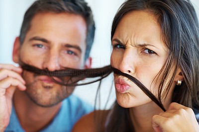 Man and woman with fake mustache