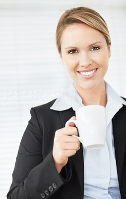 A attractive business woman holding a cup of tea or coffee
