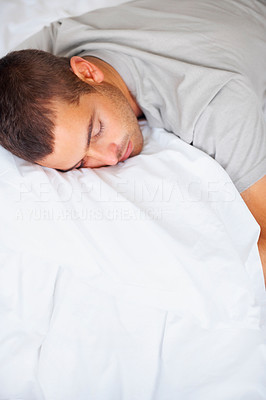Closeup of young guy sleeping on his bed