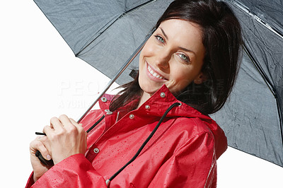 Smiling woman in raincoat holding an umbrella