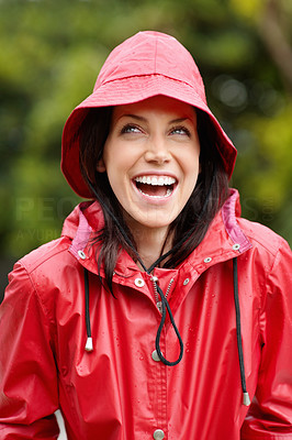 Attractive young woman in red raincoat outdoors