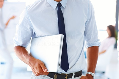 Mid section image of a business man with a laptop