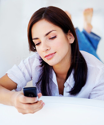 Relaxed young woman looking at cell phone