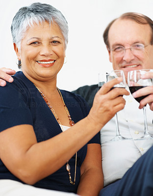 Happy elderly couple having a glass of wine together