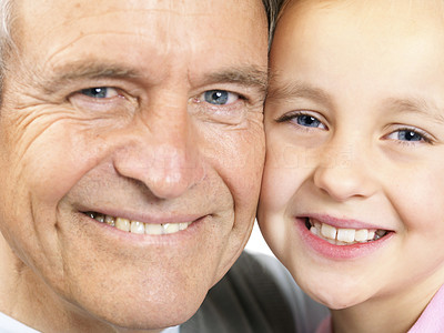 Grandfather and granddaughter smiling together