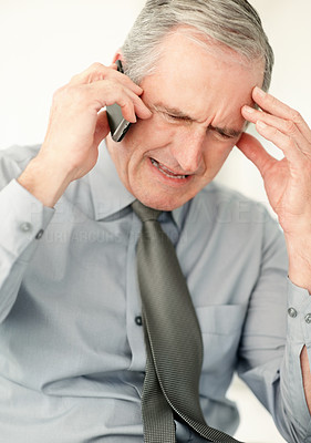 Closeup of a frustrated business man speaking on cell phone